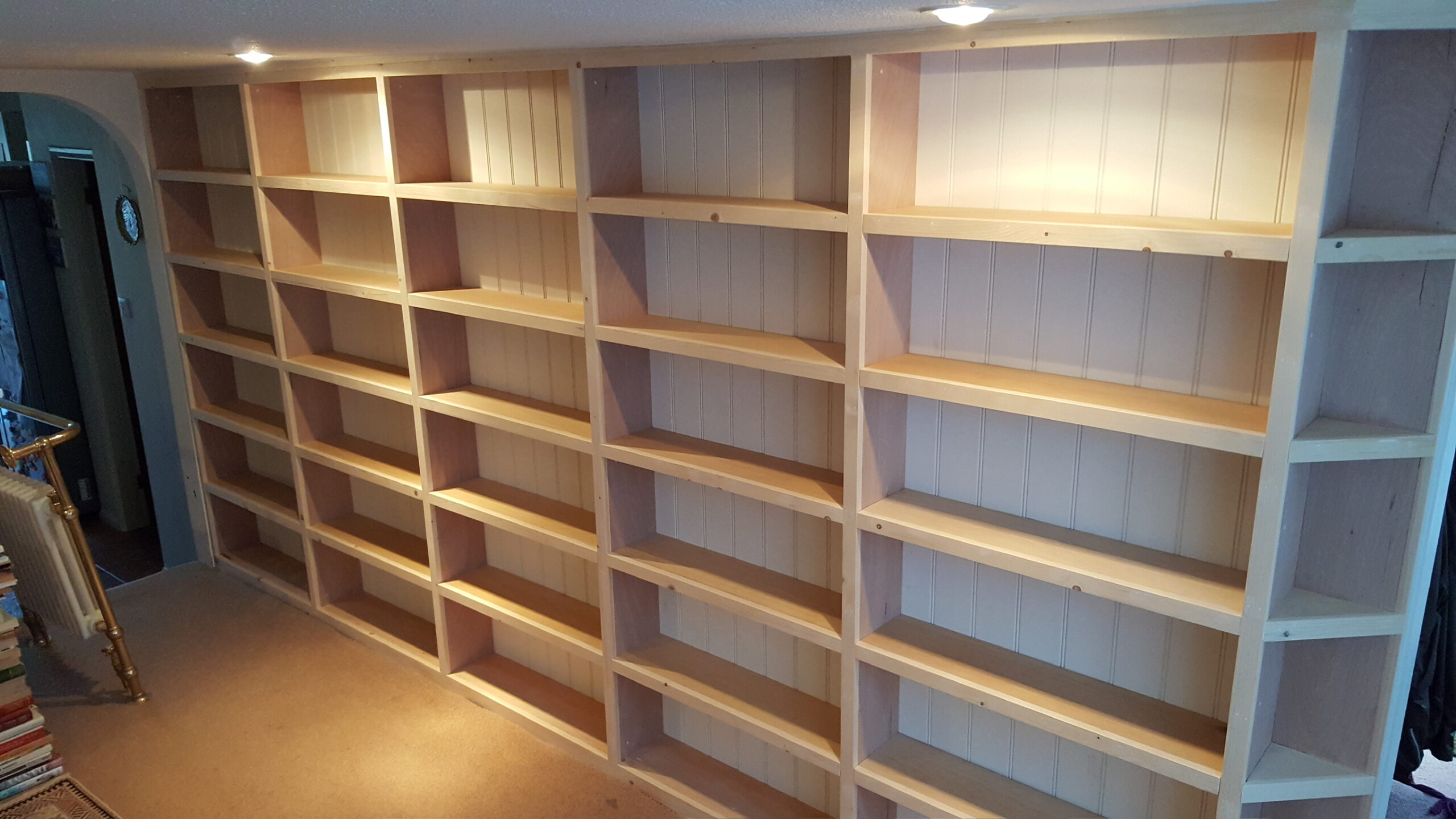 Built in bookcase in narrow hallway