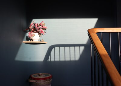 Oak handrail cast shadow on curved wall
