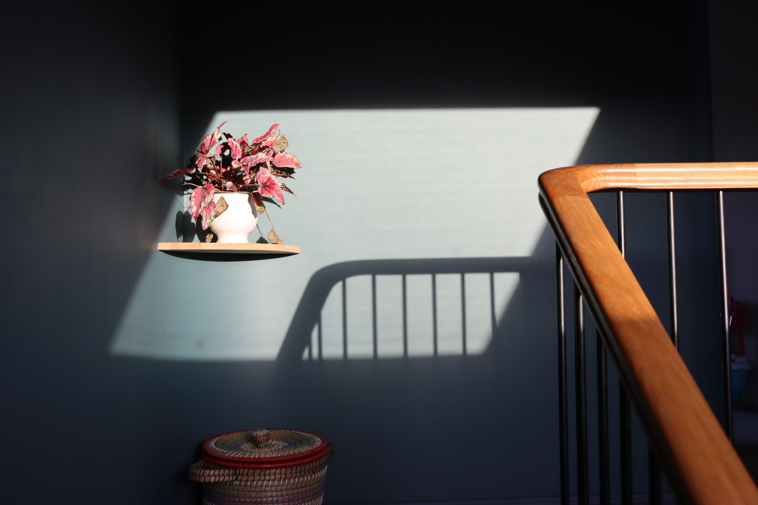 Oak handrail cast shadow on curved wall