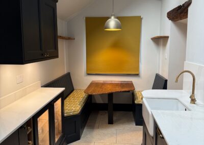 Dark blue gallery kitchen with white quartz work top