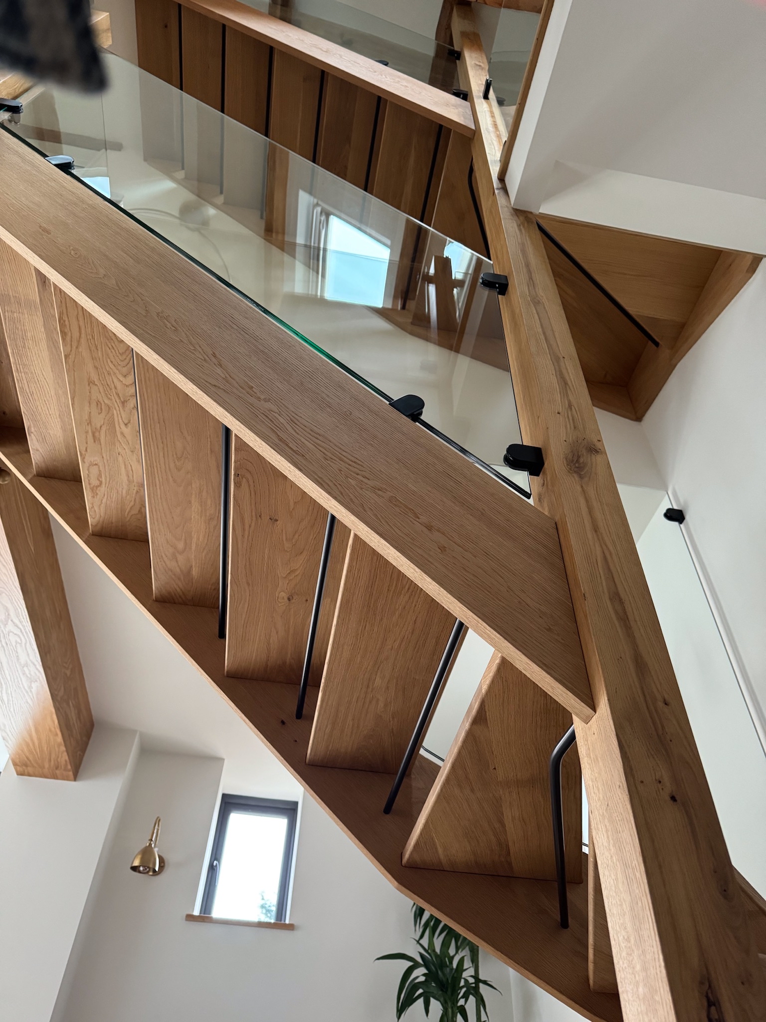 2 flights of open tread staircase with glass balastrade in barn conversion